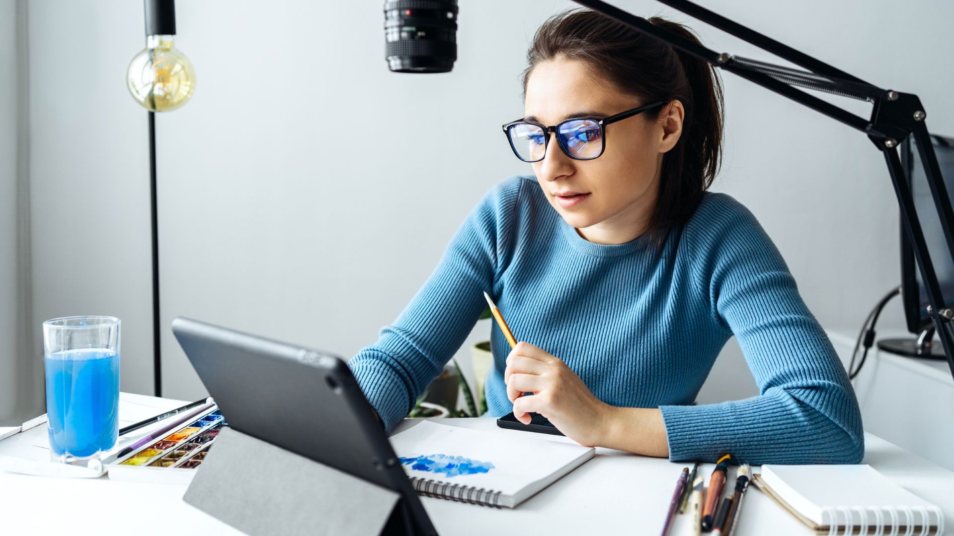 A girl in front of a tablet creating new content, representing content creation success and the importance of finding your niche.