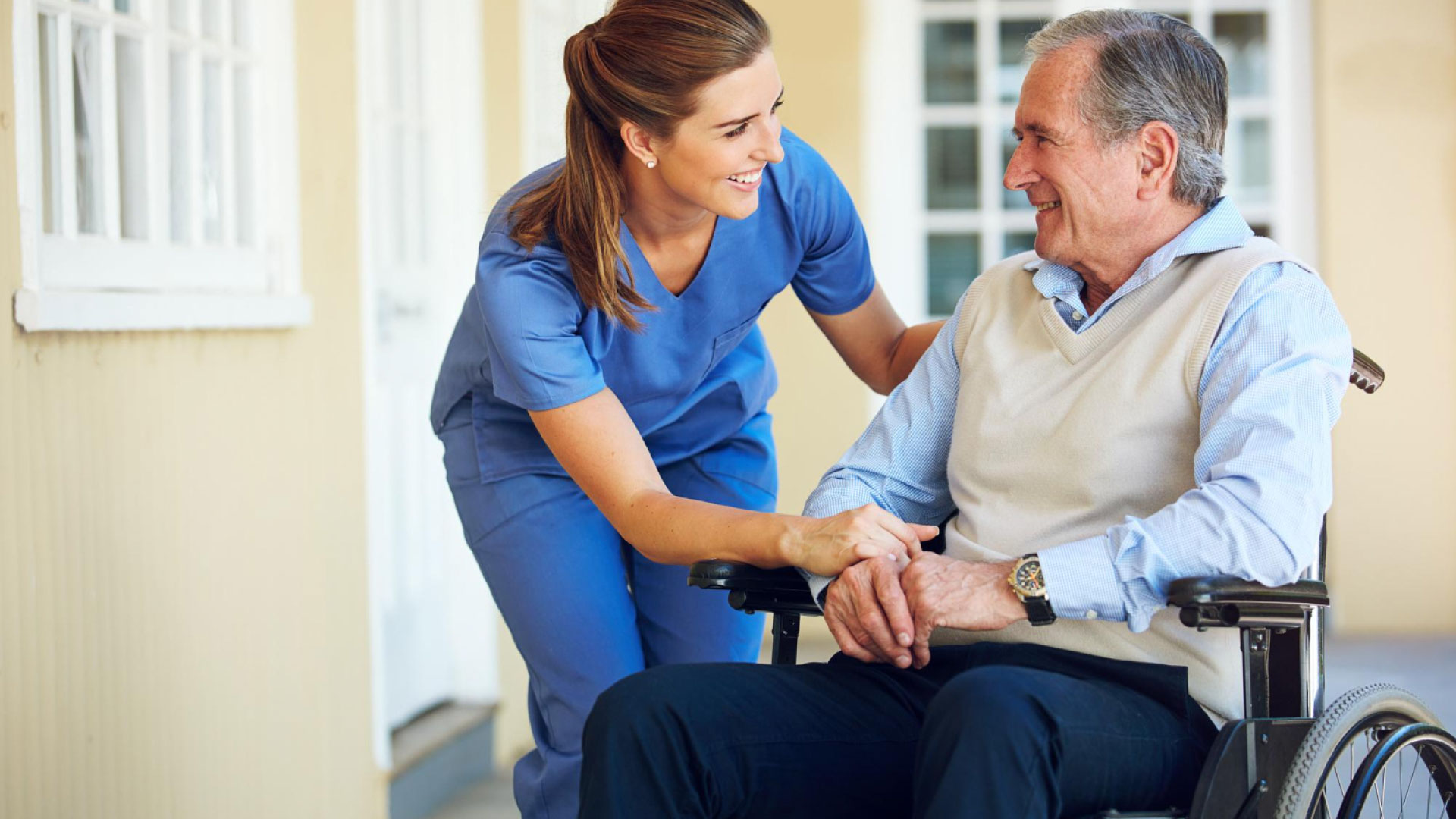 A smiling nurse caring for a patient, representing transforming patient support through empathy and innovation.